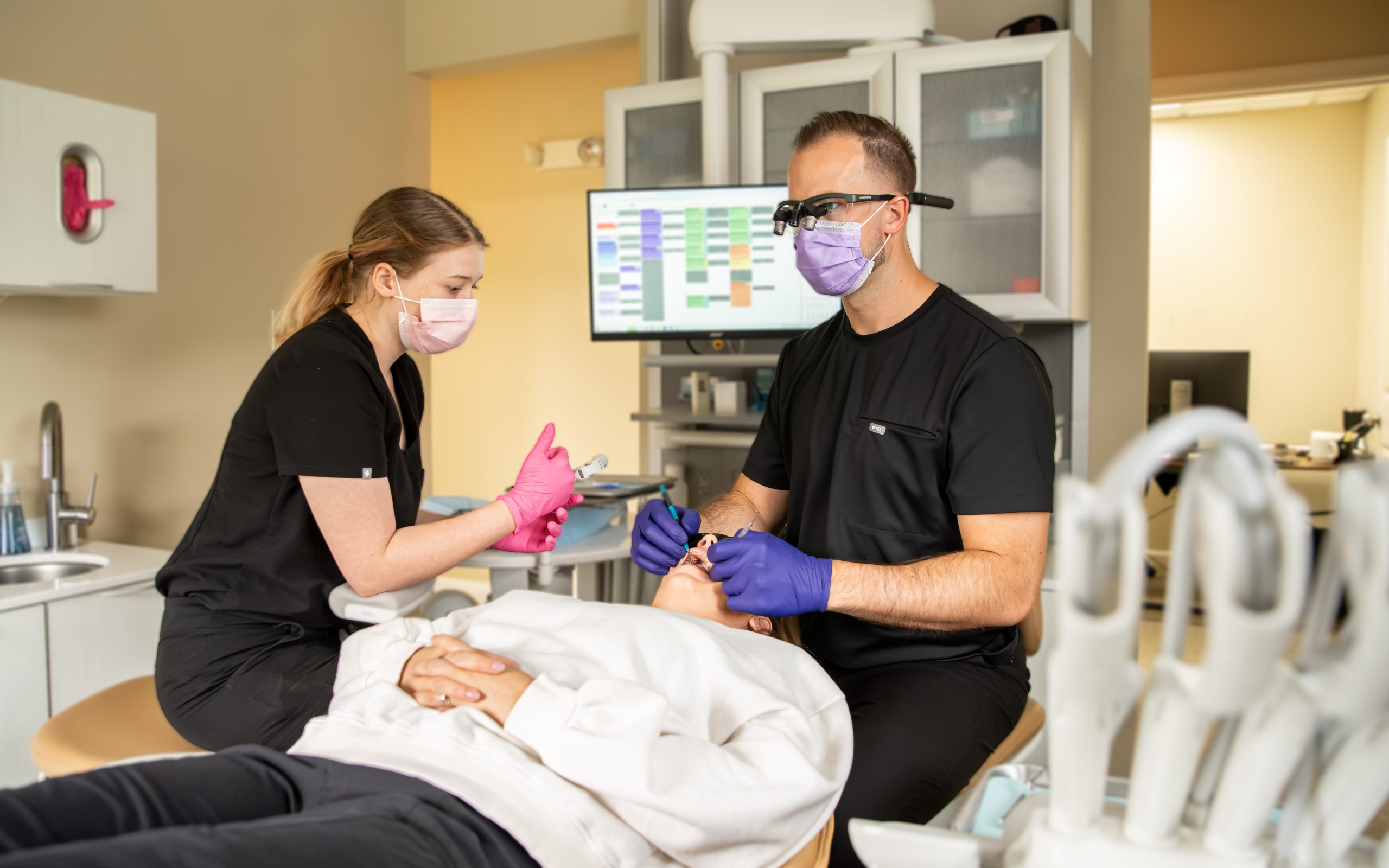 Hygienist and Dr. Kaiden Williams treating a patient at Dentistry at Walker Square in Dover, DE