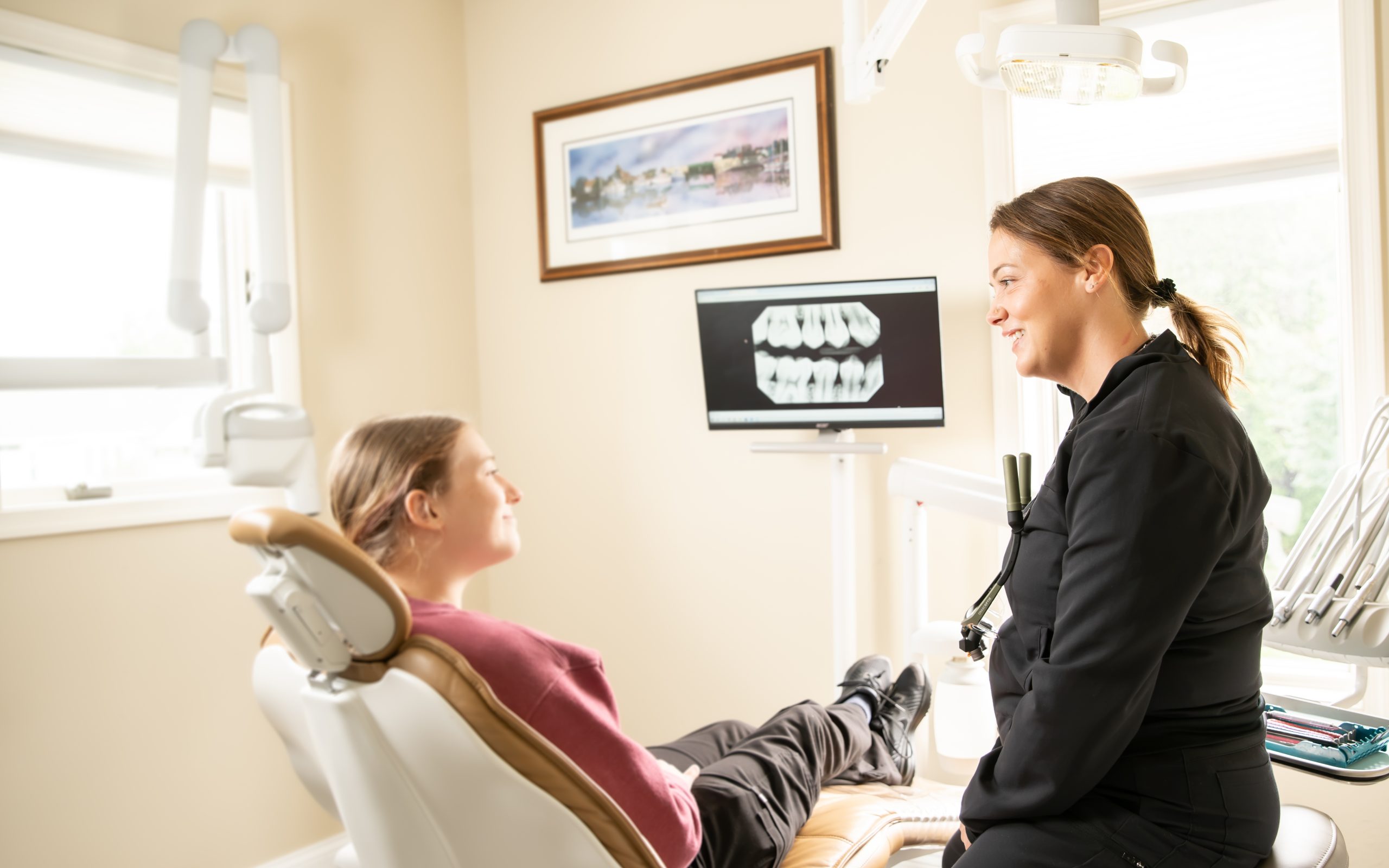 Patient reviewing dental X-rays with the team at Dentistry at Walker Square